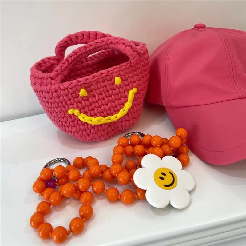 Bolso de mano de estilo occidental tejido a mano con cara sonriente para mujer